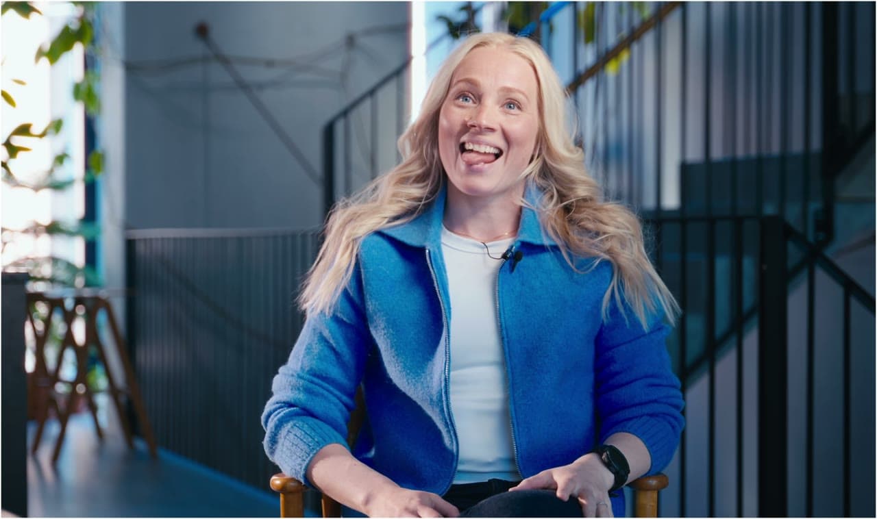 Oona in a blue jacket, mid-interview about switching to CoCoach